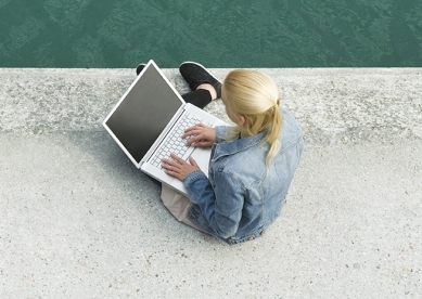 Woman jogging by lake and second woman on laptop