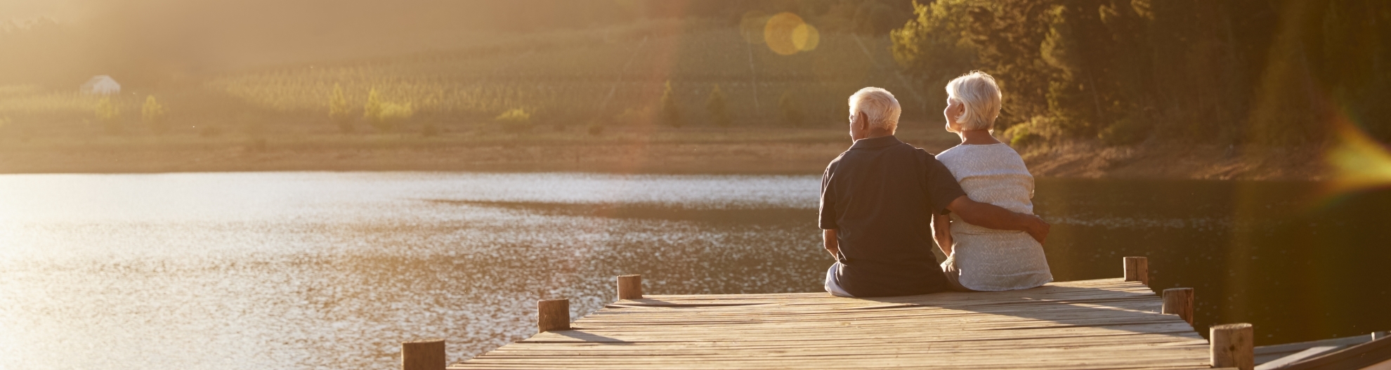 Senior couple sitting on dock