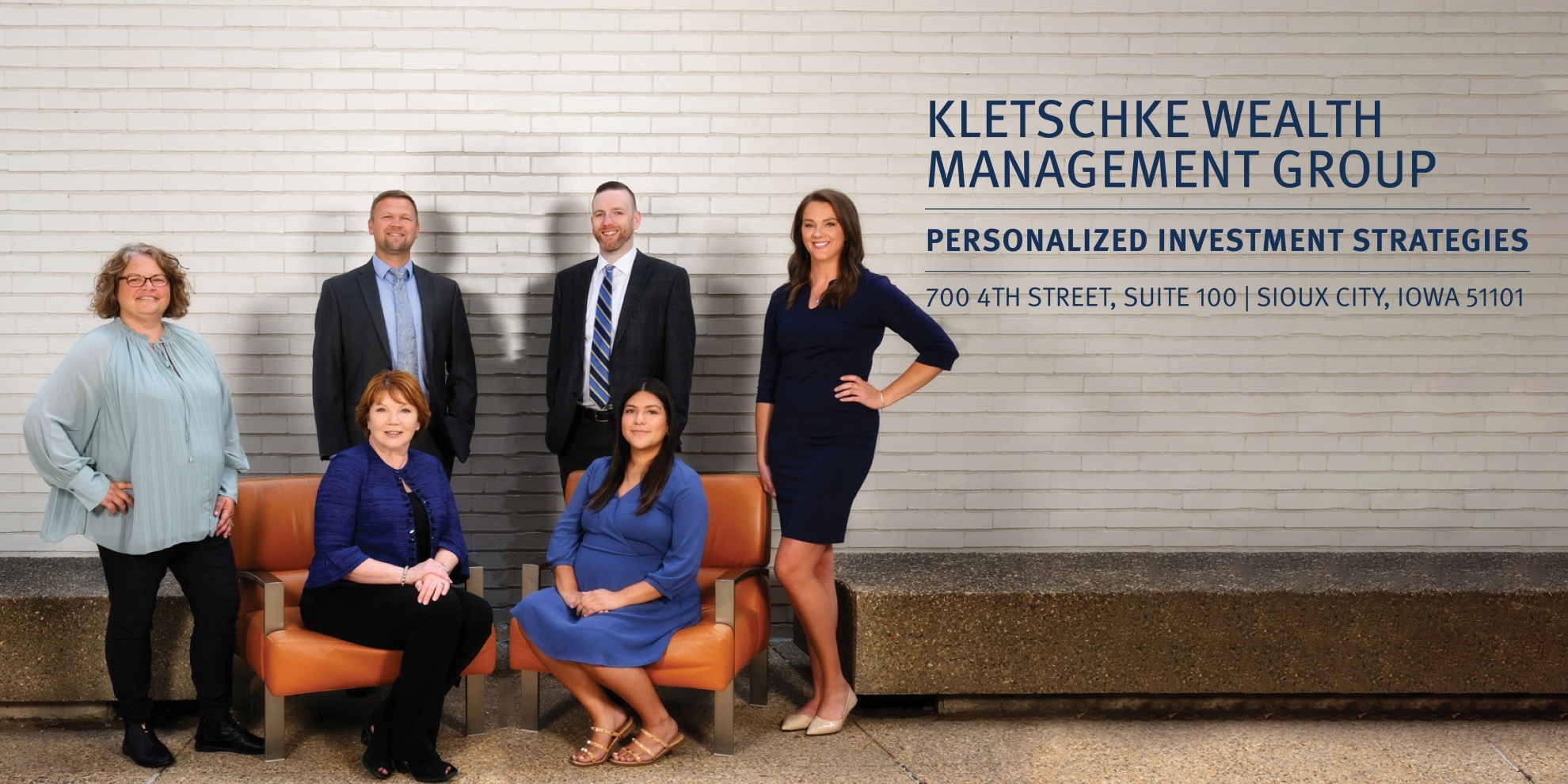 Kletschke Wealth Management Group Photo against a white brick wall; Kletschke Wealth Management Group; Personalized Investment Strategies; 700 4th Street, Suite 100 | Sioux City, Iowa 51101