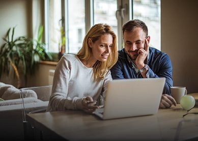 Young couple looking at laptop together