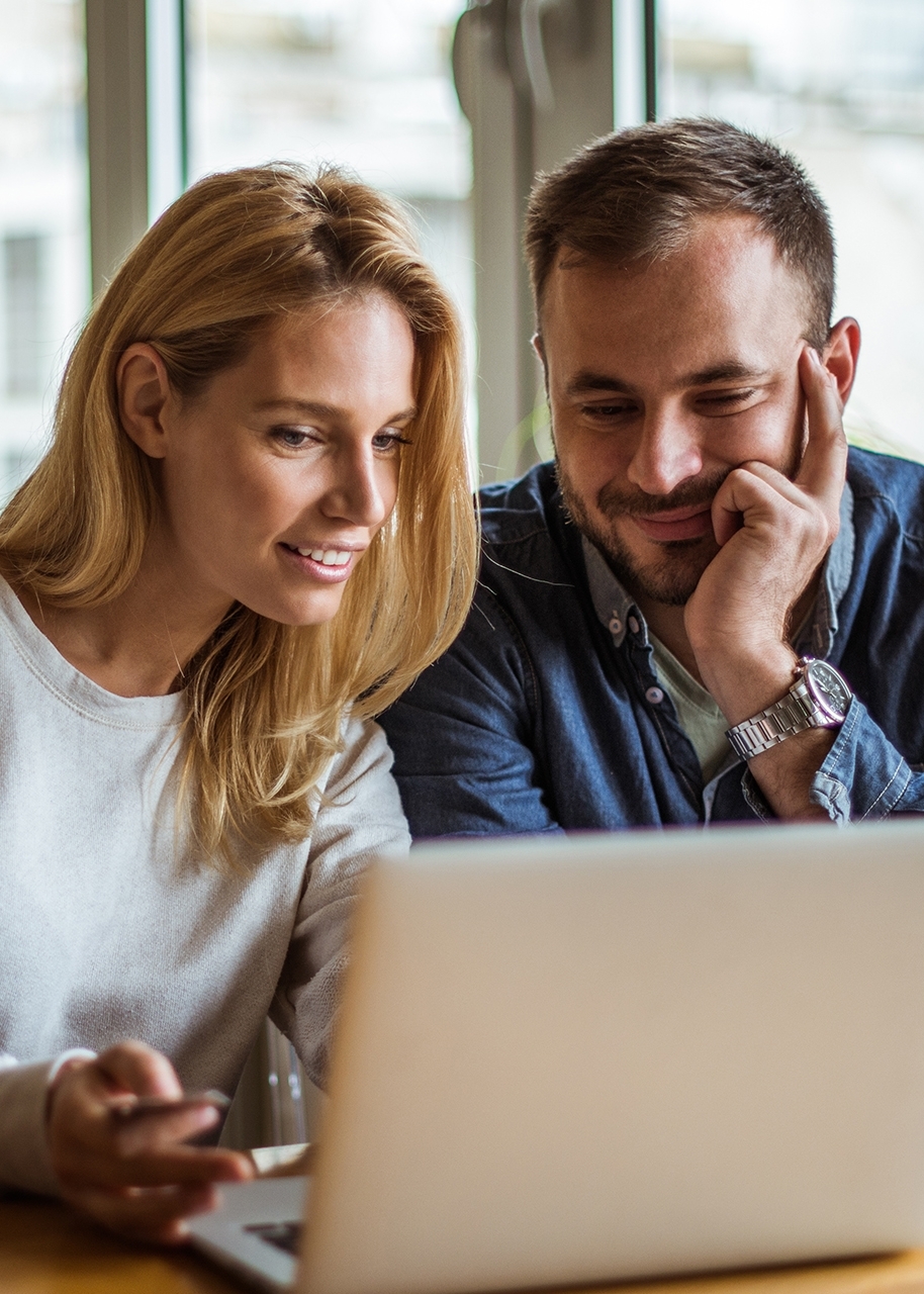 Couple looking at laptop at dinning room table